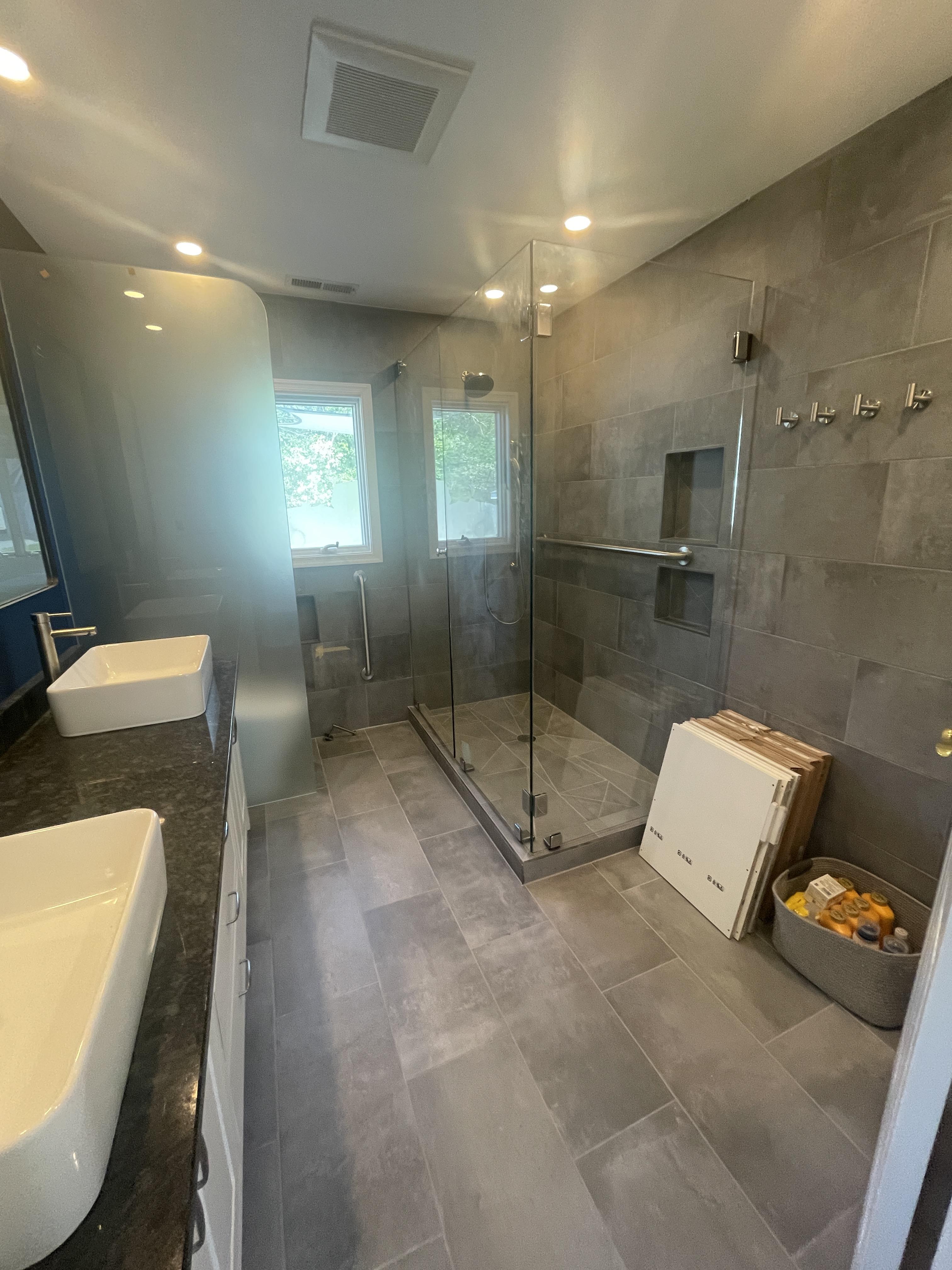 Master bath after remodeling with tiled shower and double vanity